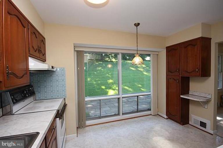 12707 Barbara Road Silver Spring, MD 20906 - Photo 8 of 21 a kitchen that has a fridge and a stove in it