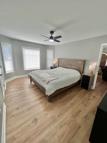 a spacious bedroom with a bed and a chandelier