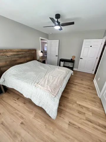 a bedroom with a bed and a chandelier