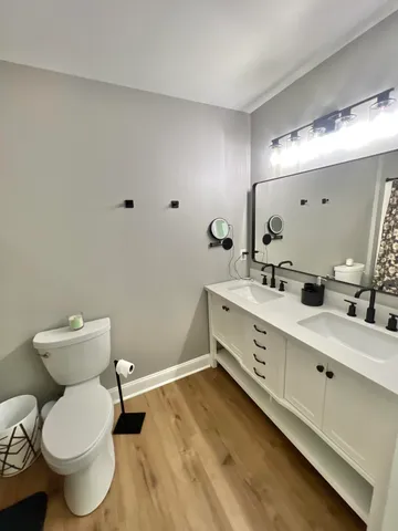 a bathroom with a toilet sink and mirror