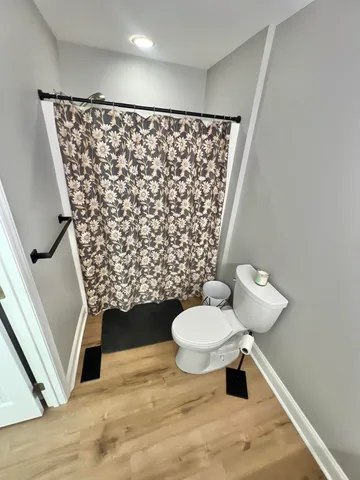 a bathroom with a toilet and a shower