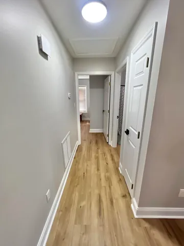 a view of a bathroom with sink and wooden floor