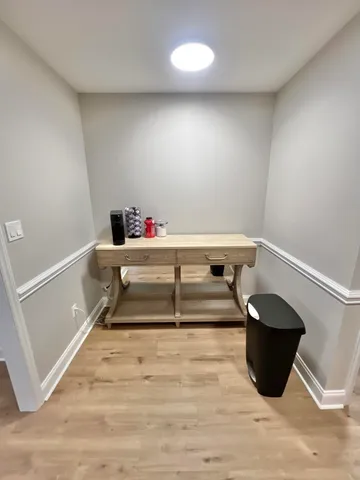 a room with hard wood floor and a window