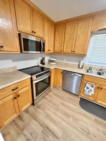 a kitchen with granite countertop a stove a sink and a microwave
