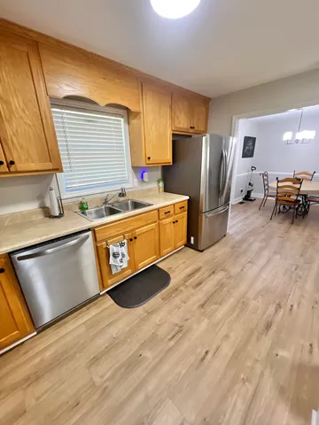 a kitchen with stainless steel appliances granite countertop a sink stove and refrigerator
