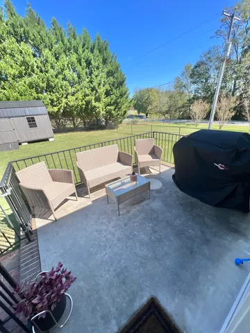 a view of a chairs and table in the patio