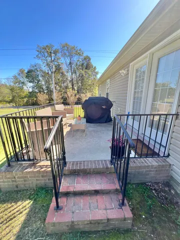 a view of a patio with a table chairs and a patio