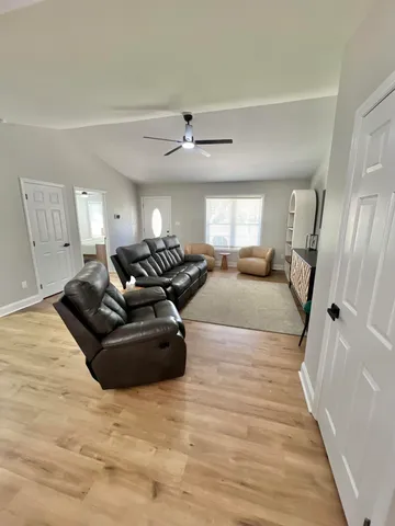 a large bedroom with a bed and wooden floor