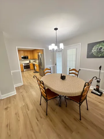 a view of a dining room with furniture and wooden floor