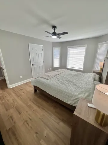 a bedroom with a bed and a ceiling fan