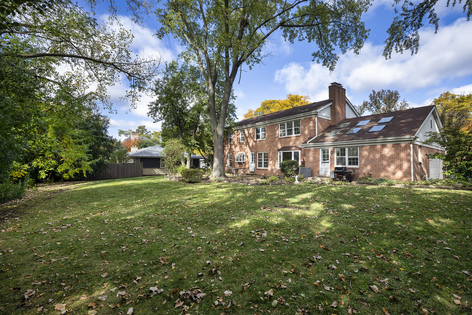 3815 Bordeaux Drive Northbrook, IL 60062 - Photo 2 of 56 a view of a big yard with plants and a fountain