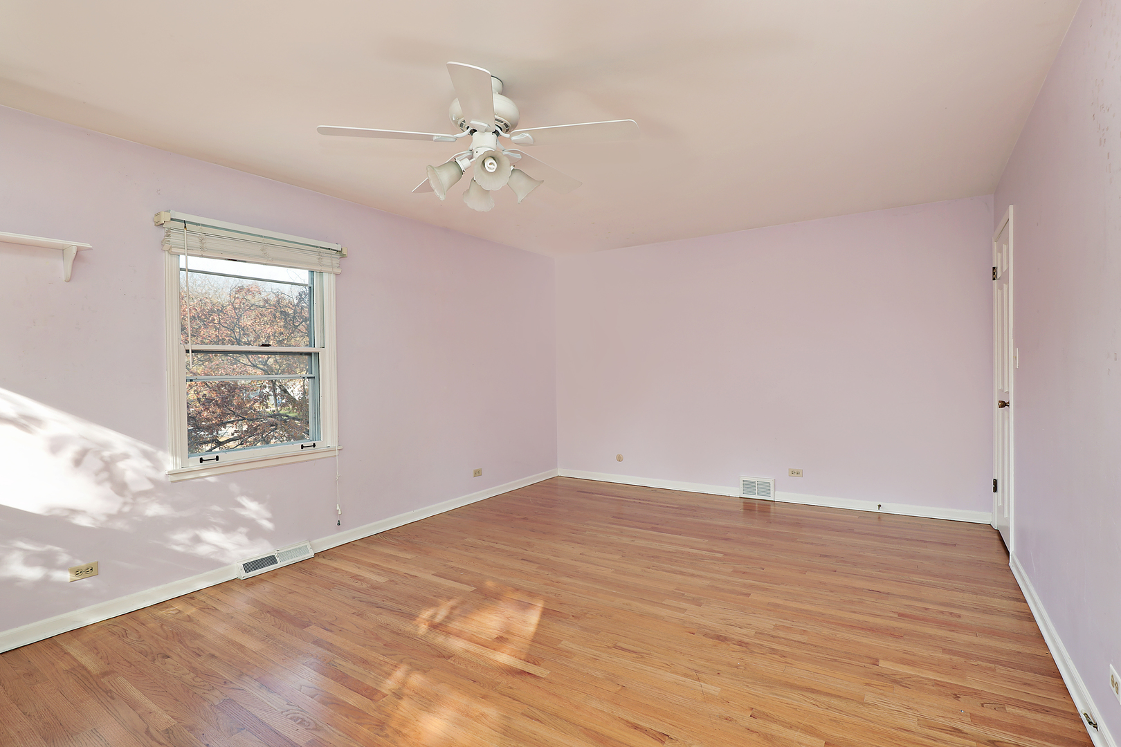 3815 Bordeaux Drive Northbrook, IL 60062 - Photo 29 of 56 an empty room with wooden floor chandelier fan and windows