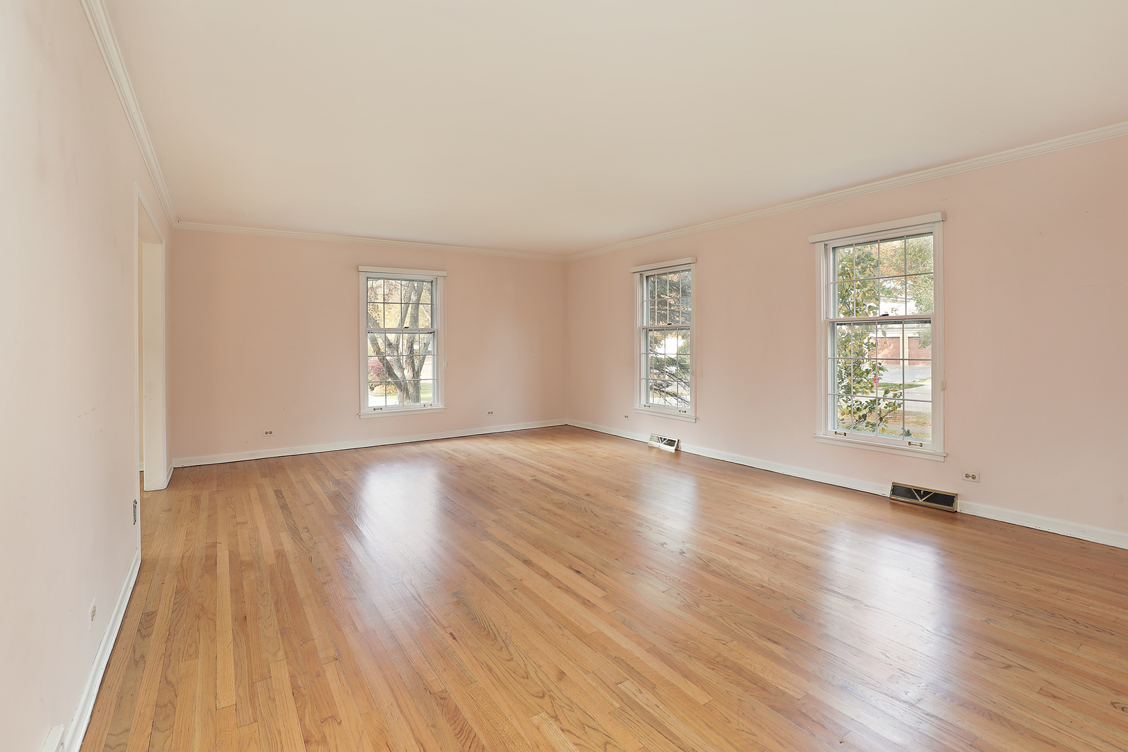 3815 Bordeaux Drive Northbrook, IL 60062 - Photo 8 of 56 an empty room with wooden floor and windows