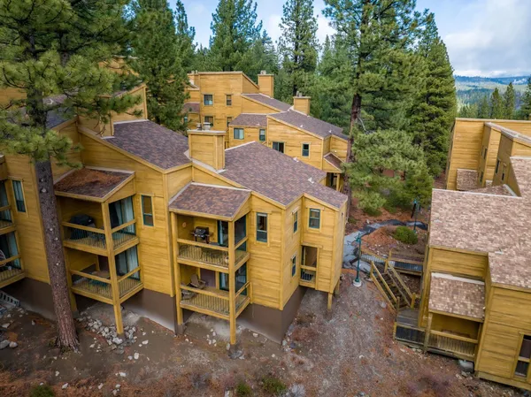 an aerial view of a house with a yard and balcony