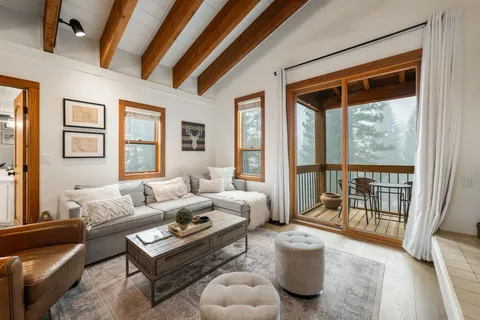 a living room with furniture and a floor to ceiling window