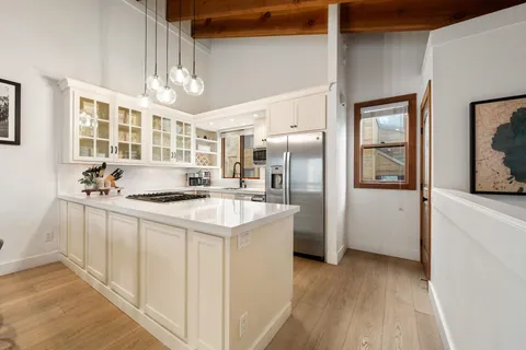 a kitchen with stainless steel appliances granite countertop a sink stove and refrigerator