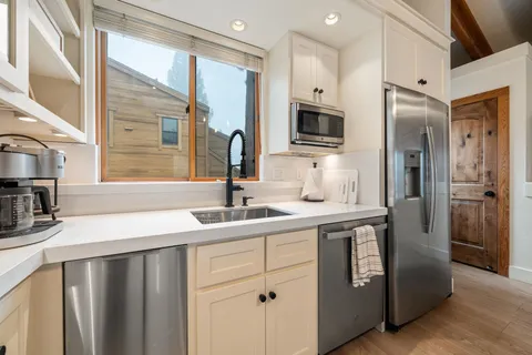 a kitchen with stainless steel appliances a sink stove and refrigerator