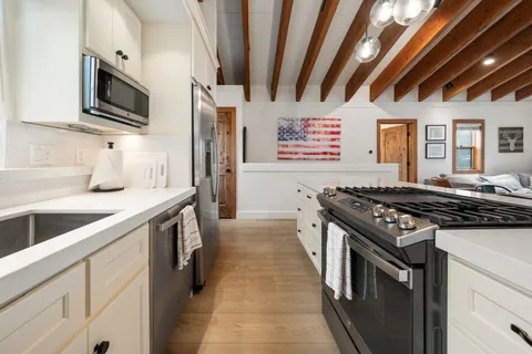 a kitchen with stainless steel appliances granite countertop a stove and a sink