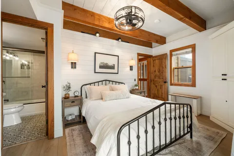 a bedroom with a bed and a chandelier