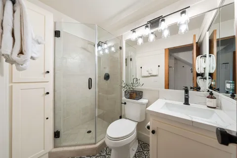 a bathroom with a sink toilet and shower