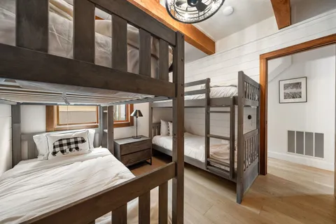 a bedroom with a bed a mirror and a window