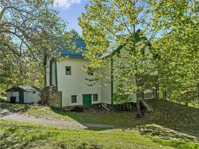 a big yard with lots of green space and trees