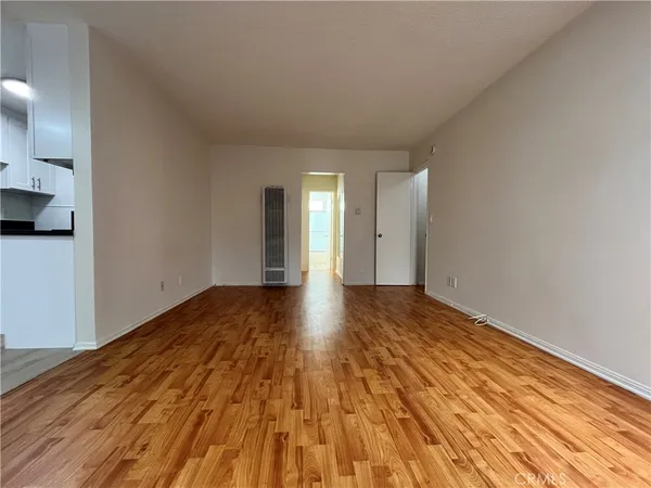 a view of an empty room and wooden floor