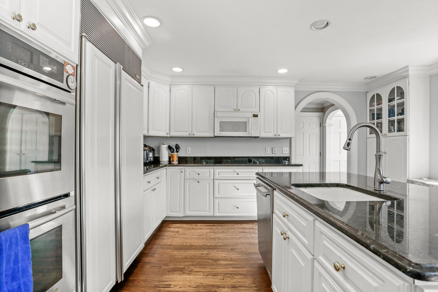 110 Gower Road New Canaan, CT 06840 - Photo 13 of 39 a kitchen with granite countertop white cabinets and stainless steel appliances