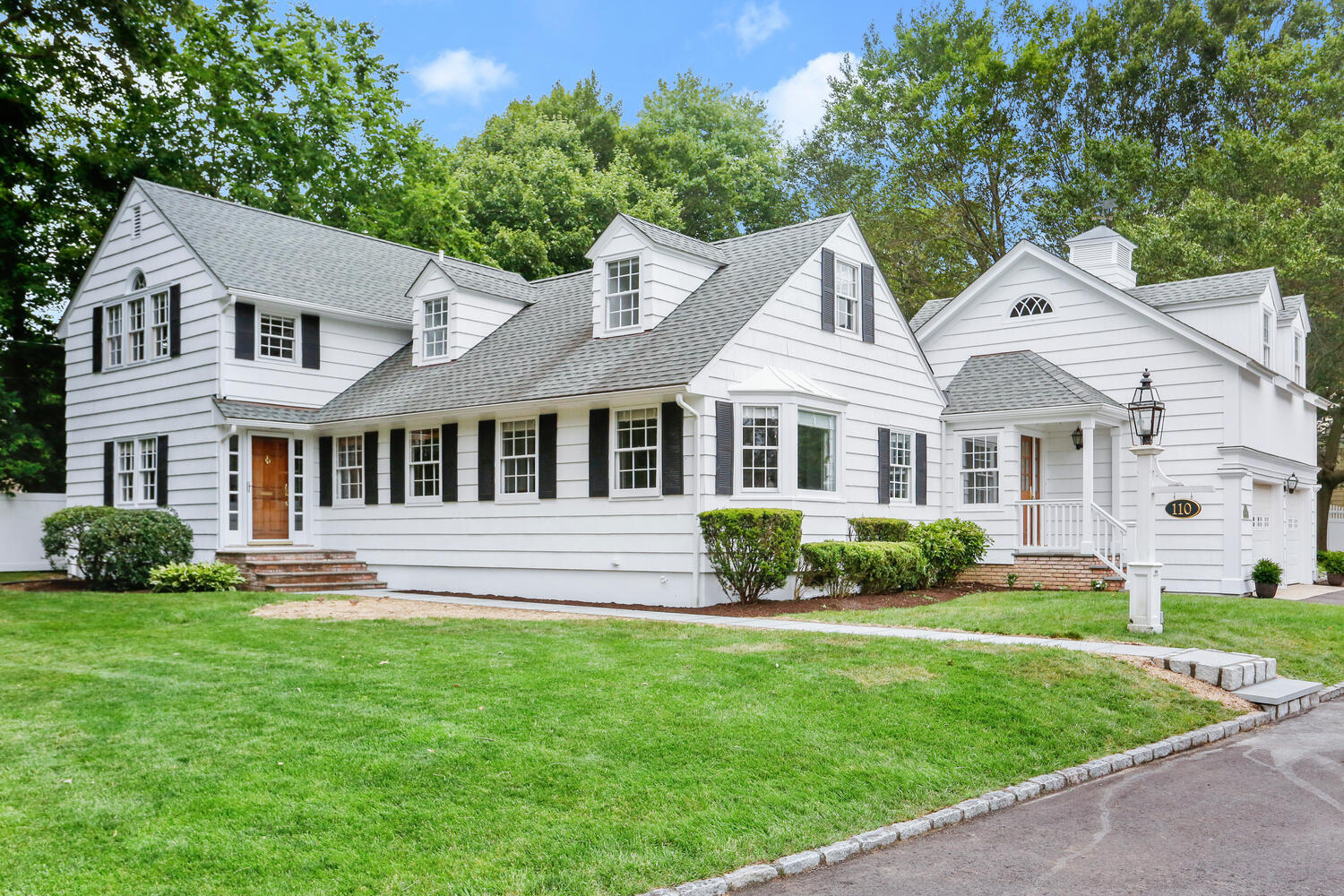 110 Gower Road New Canaan, CT 06840 - Photo 26 of 39 a front view of a house with a yard