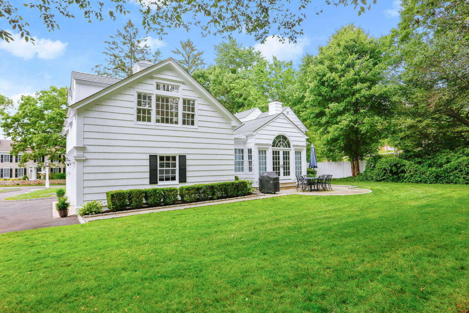 110 Gower Road New Canaan, CT 06840 - Photo 28 of 39 a front view of a house with a yard and trees