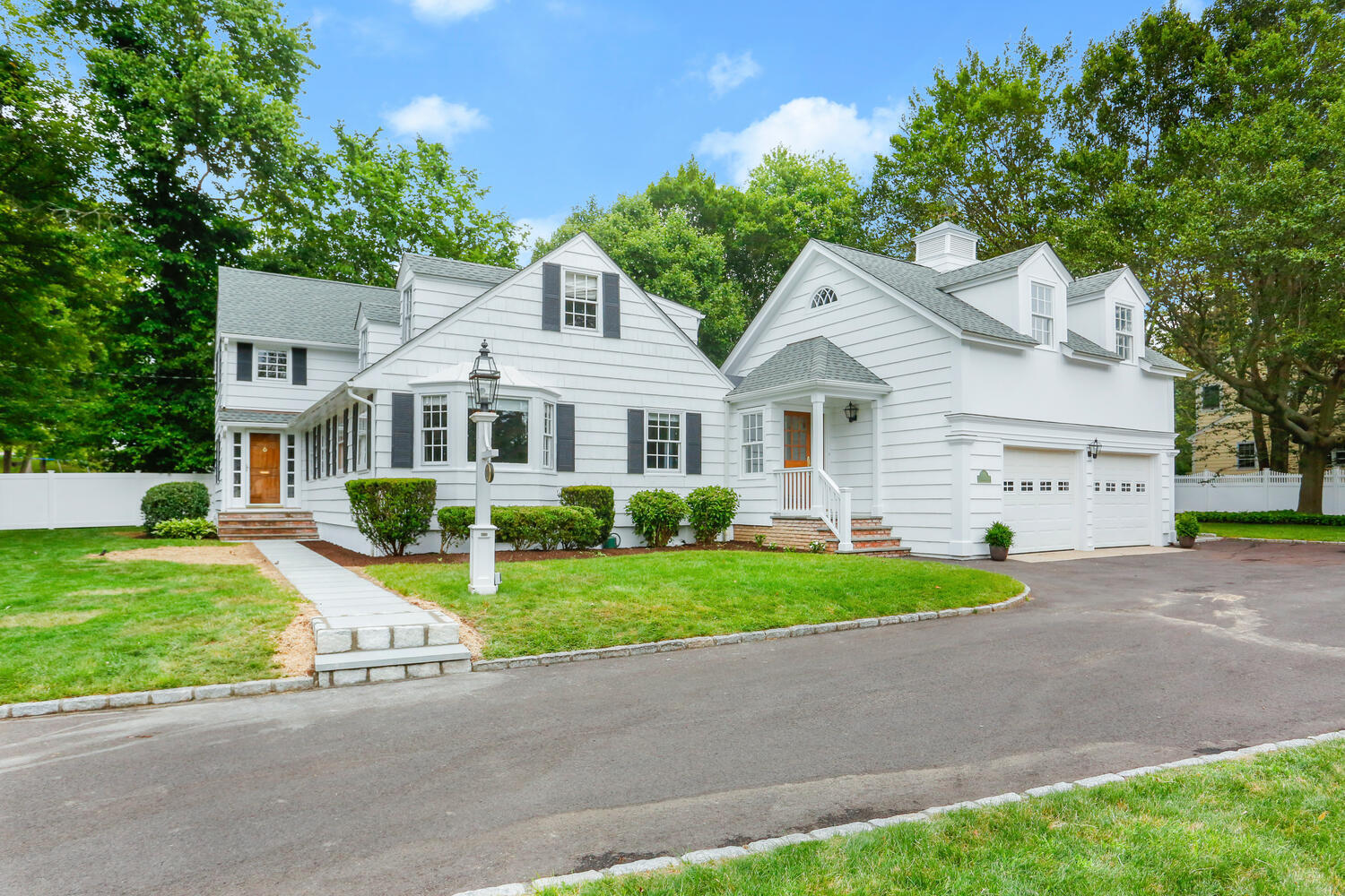 110 Gower Road New Canaan, CT 06840 - Photo 33 of 39 a front view of a house with a yard and garage