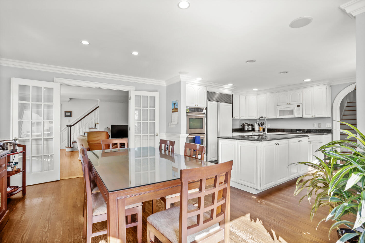 110 Gower Road New Canaan, CT 06840 - Photo 10 of 39 a kitchen with stainless steel appliances kitchen island granite countertop a dining table chairs and granite counter tops