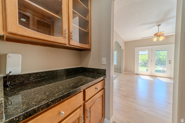 598 Hollow Creek Road Draper, UT 84020 - Photo 32 of 110 Built-in cabinetry with glass-front upper cabinets and a dark granite-finish countertop