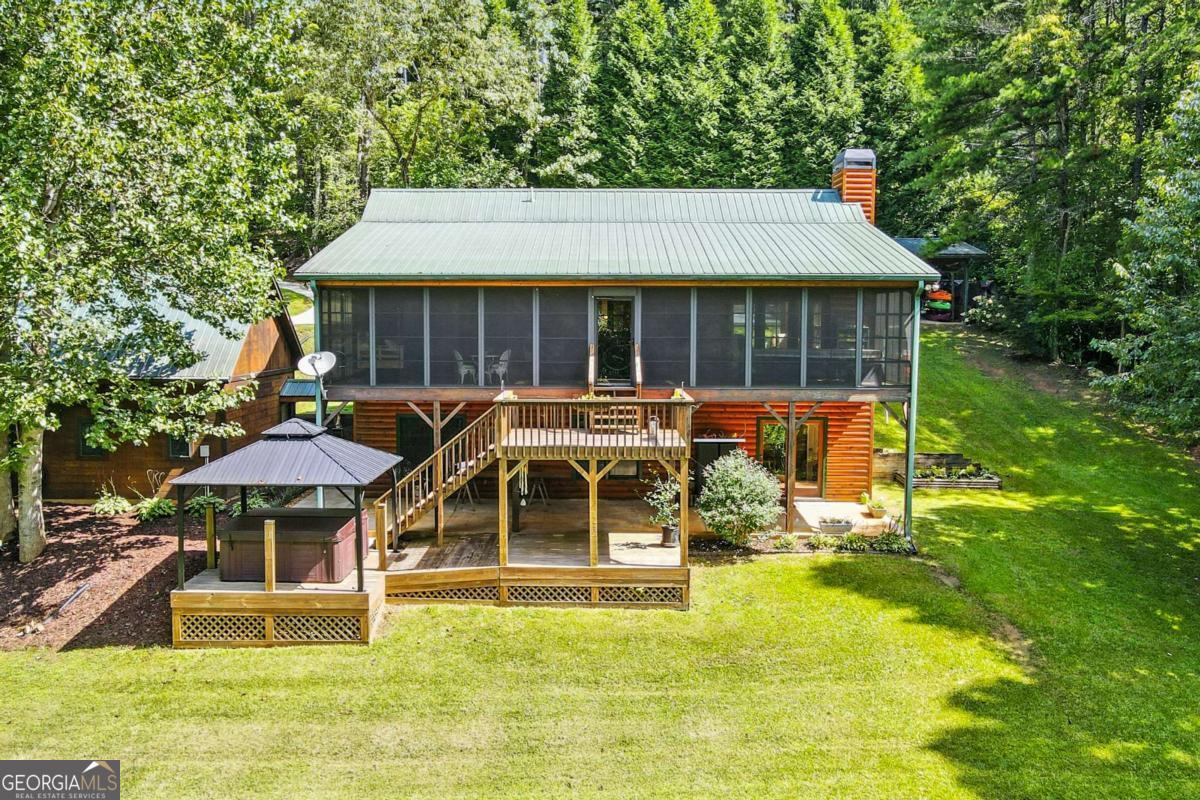 772 Rickman Airfield Road Clayton, GA 30525 - Photo 14 of 64 a front view of a house with a yard table and chairs