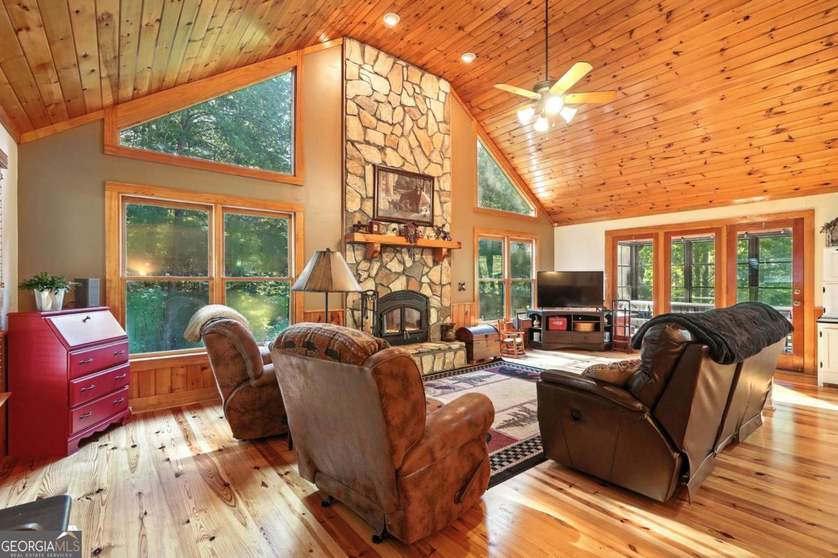 772 Rickman Airfield Road Clayton, GA 30525 - Photo 20 of 64 a living room with fireplace furniture and a large window