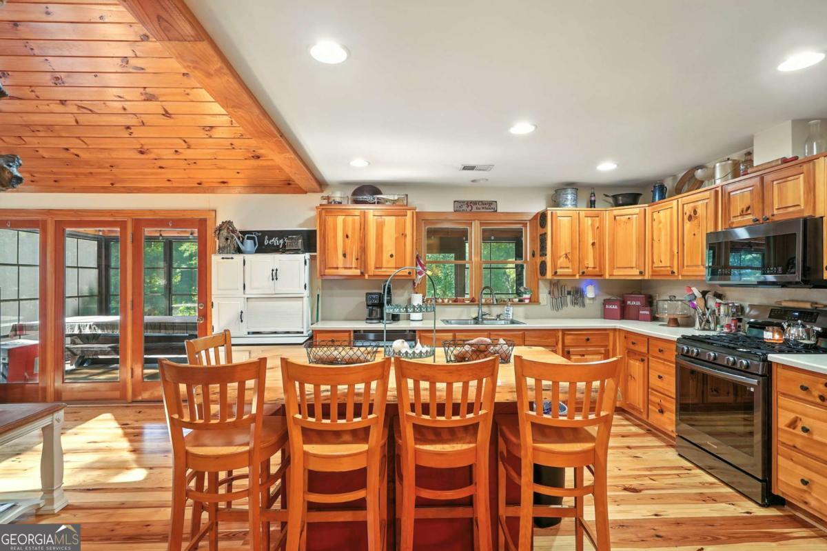 772 Rickman Airfield Road Clayton, GA 30525 - Photo 25 of 64 a kitchen with stainless steel appliances granite countertop a stove and cabinets