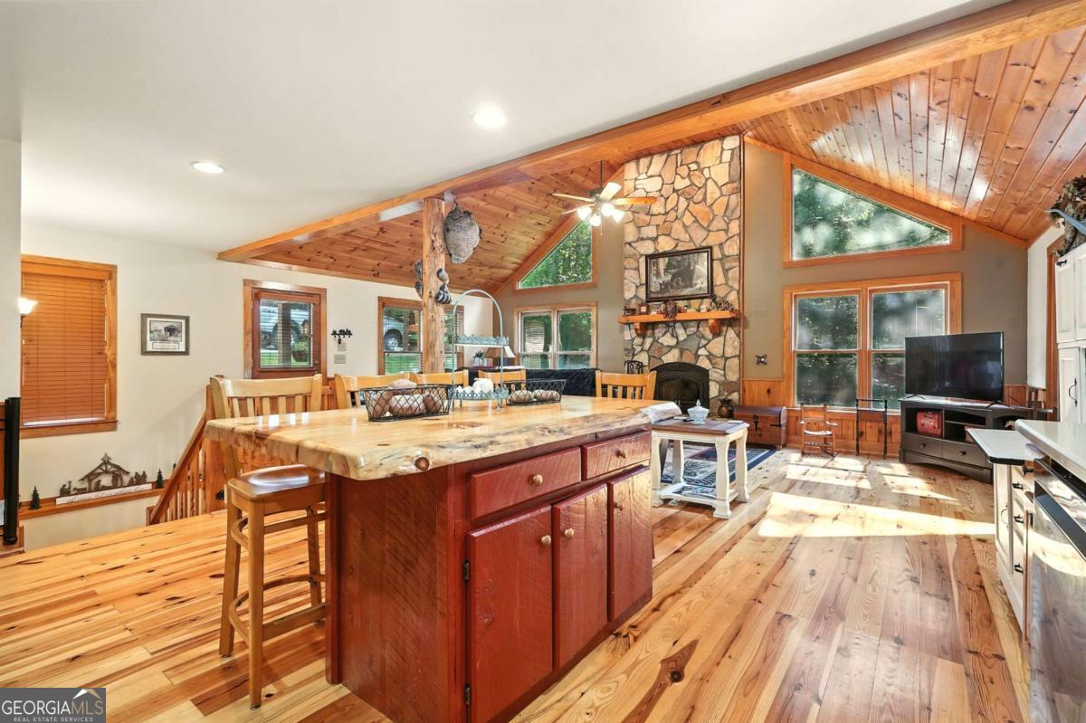 772 Rickman Airfield Road Clayton, GA 30525 - Photo 27 of 64 a view of a kitchen with kitchen island granite countertop a large window a sink and a counter top space