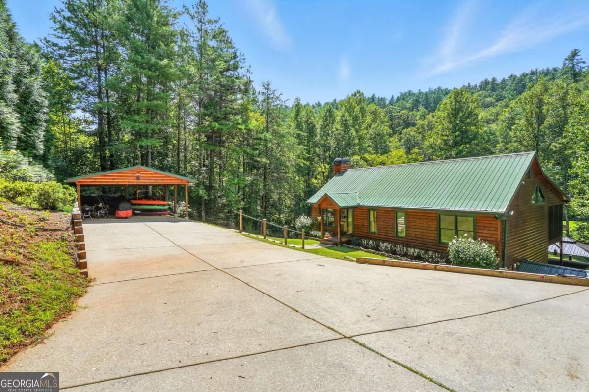772 Rickman Airfield Road Clayton, GA 30525 - Photo 3 of 64 a front view of a house with a yard and trees