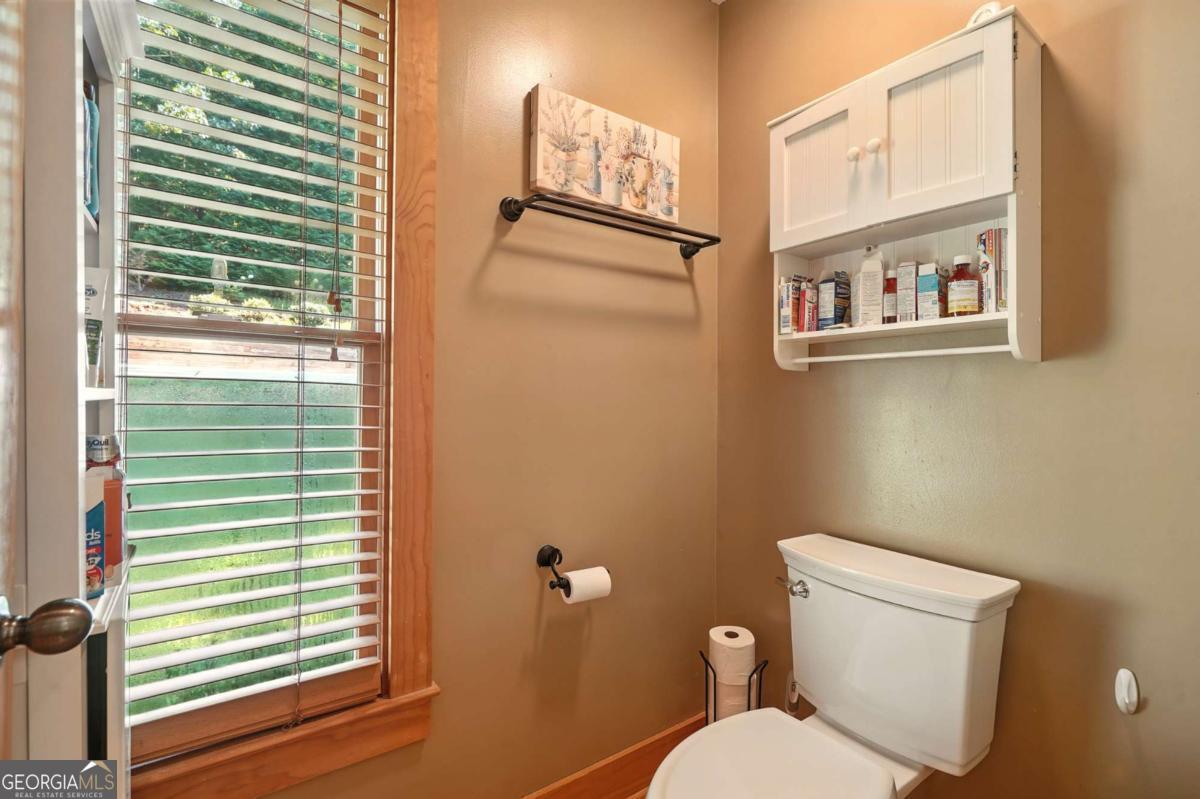 772 Rickman Airfield Road Clayton, GA 30525 - Photo 31 of 64 a white toilet sitting next to a window