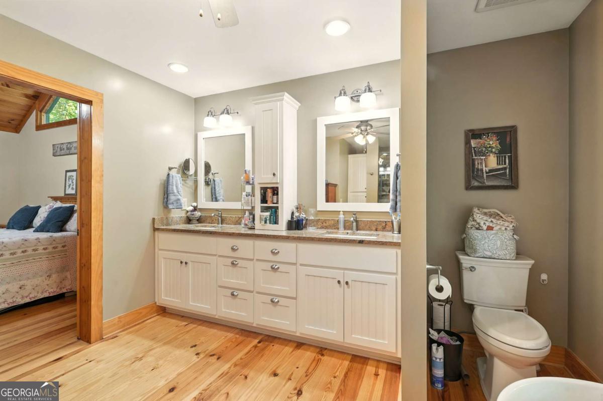 772 Rickman Airfield Road Clayton, GA 30525 - Photo 37 of 64 a bathroom with a toilet sink and mirror