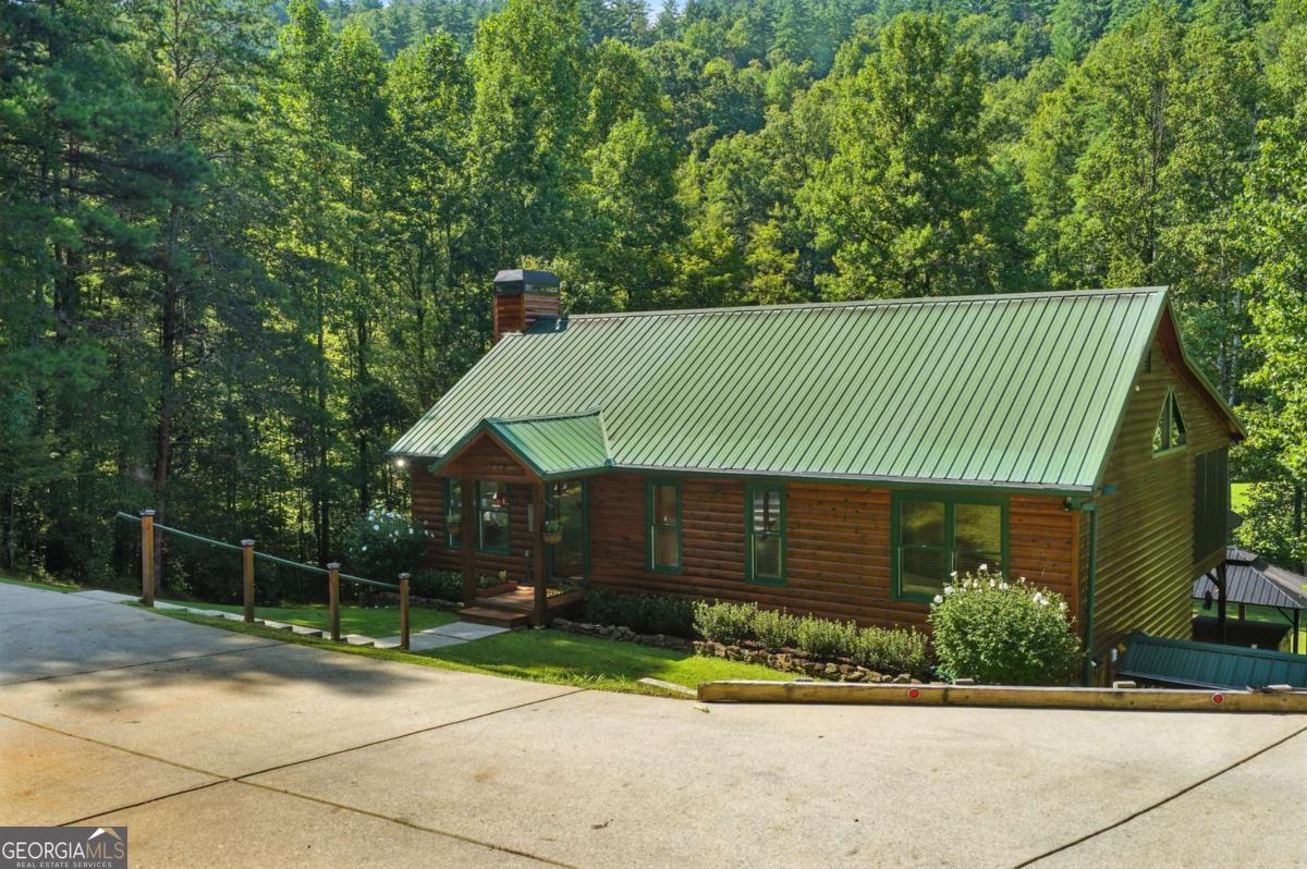772 Rickman Airfield Road Clayton, GA 30525 - Photo 5 of 64 a front view of a house with a garden