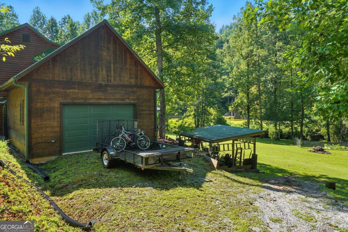 772 Rickman Airfield Road Clayton, GA 30525 - Photo 51 of 64 a backyard of a house with table and chairs