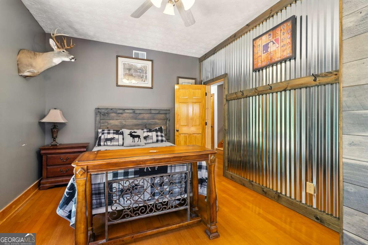 772 Rickman Airfield Road Clayton, GA 30525 - Photo 54 of 64 a bedroom with a bed and wooden floor