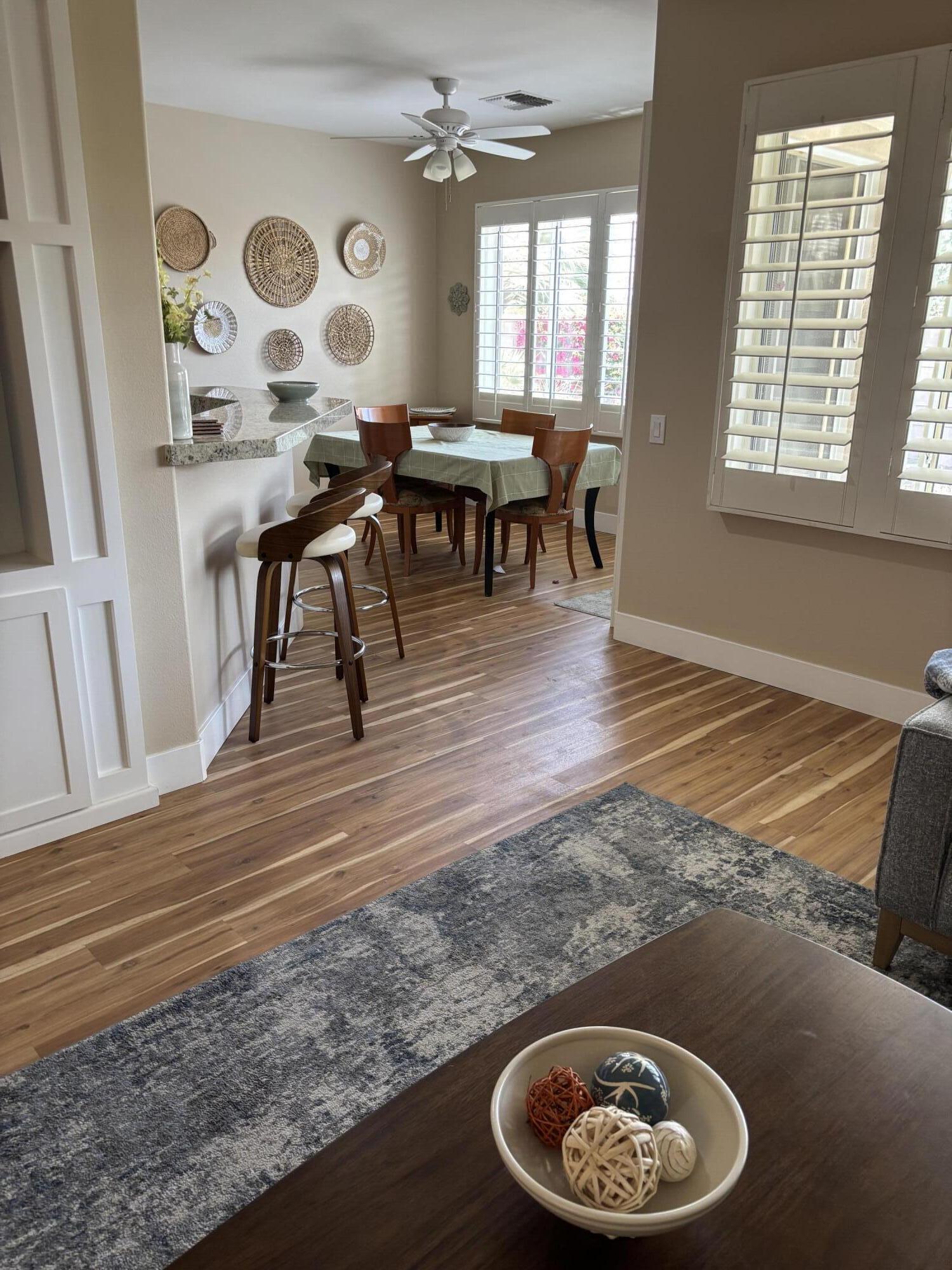 78724 Palm Tree Avenue Palm Desert, CA 92211 - Photo 4 of 14 a view of a dining room with furniture and wooden floor