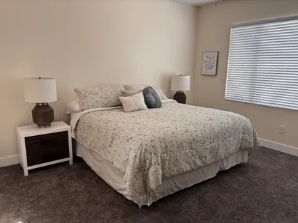 a bedroom with a bed and a window