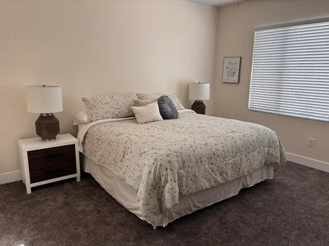 a bedroom with a bed and a window