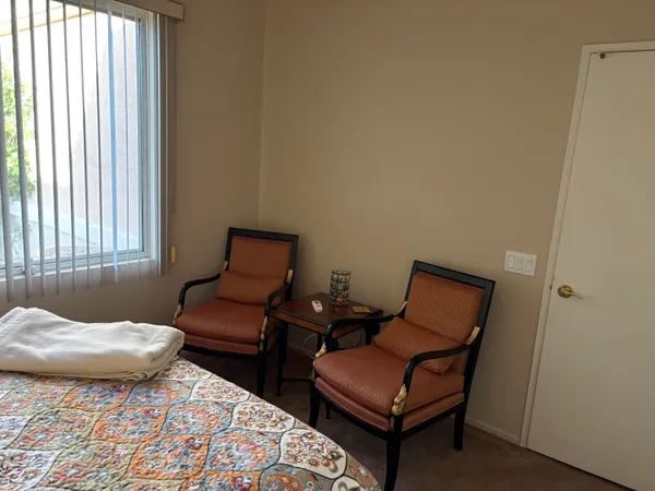 a bedroom with a bed and window