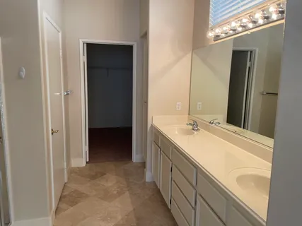 a bathroom with a double vanity sink and mirror