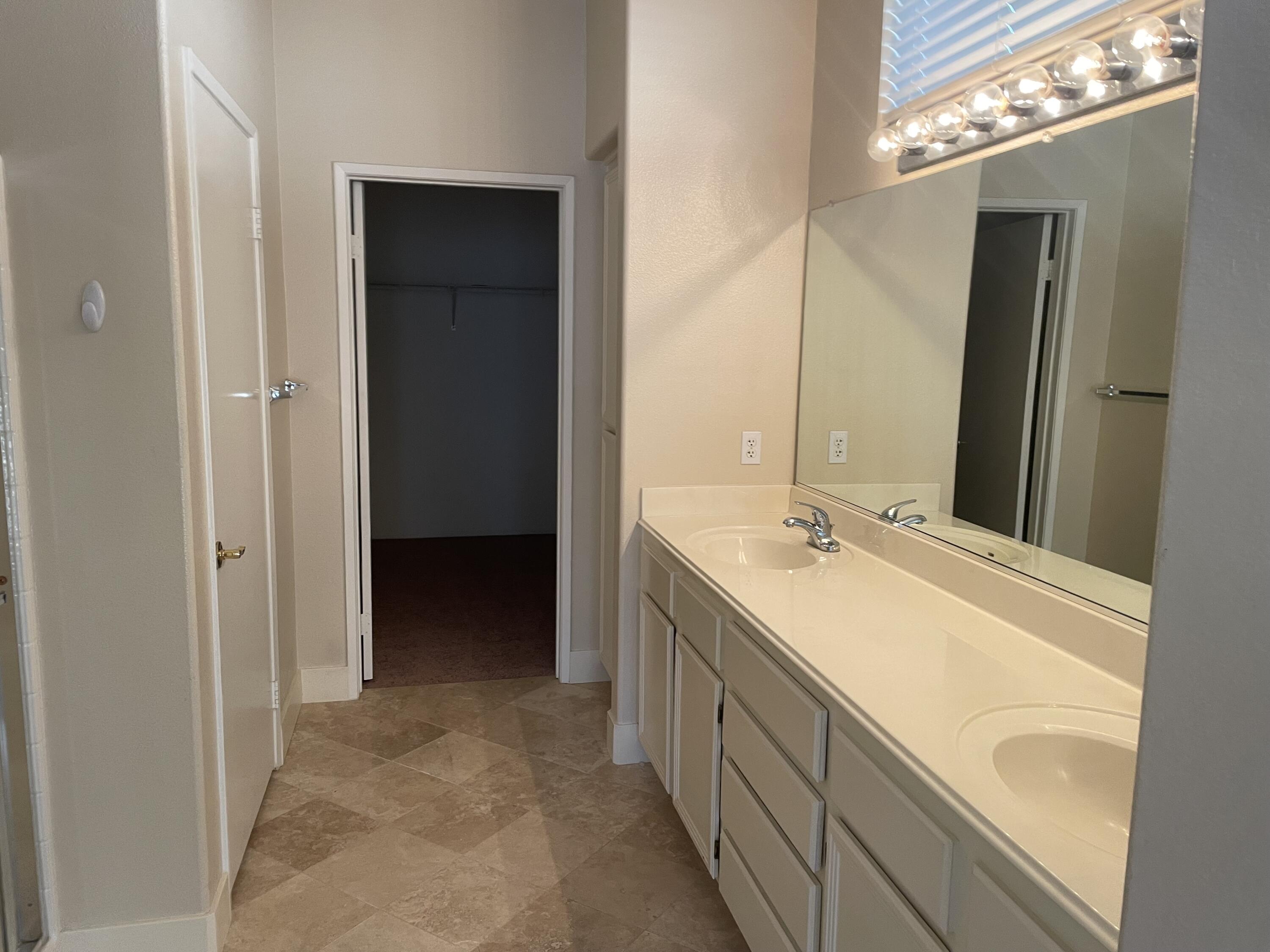 78724 Palm Tree Avenue Palm Desert, CA 92211 - Photo 10 of 14 a bathroom with a double vanity sink and mirror