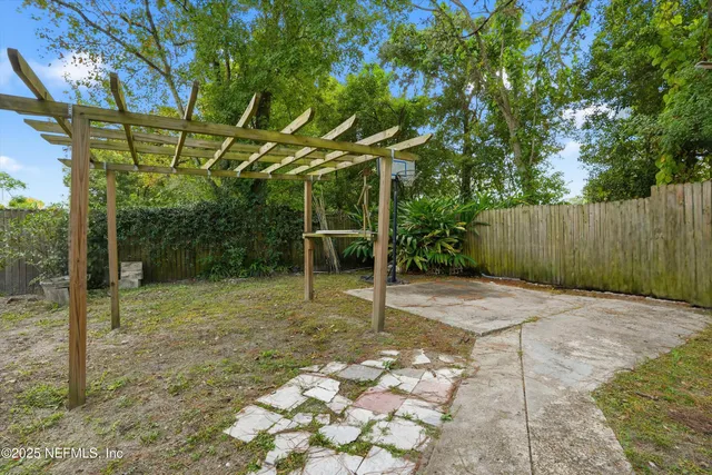 a backyard of a house with a tree